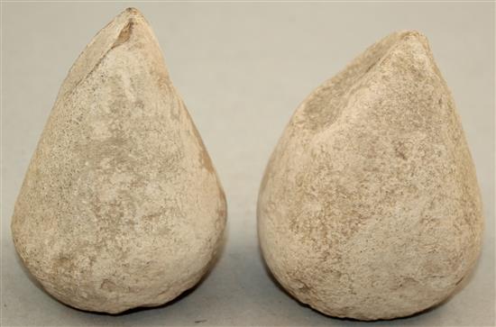 A pair of Greek stone loom weights, c.3rd century BC, 8.5cm and 9.5cm